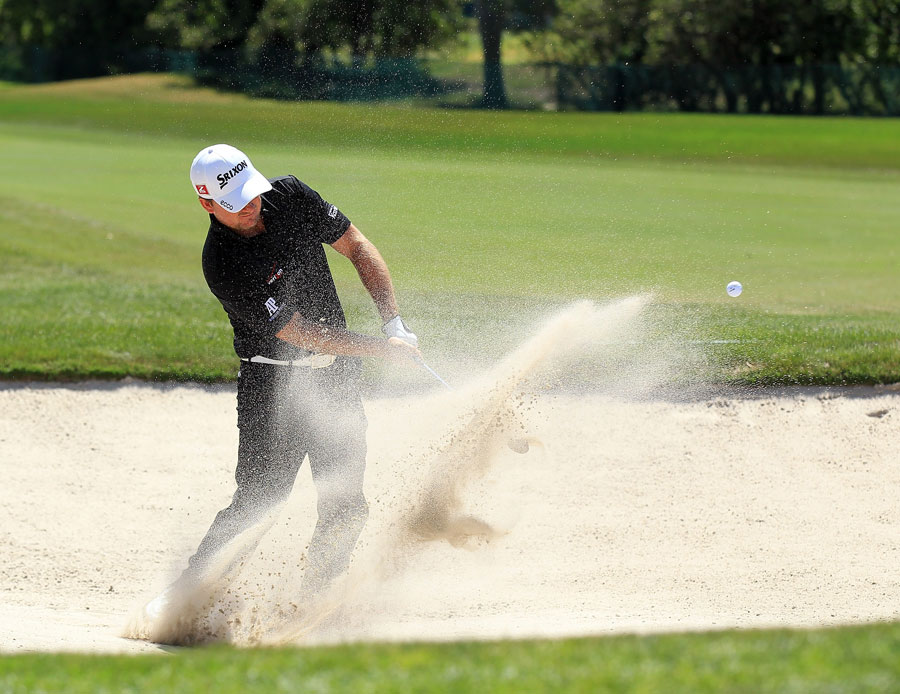 Graeme McDowell plays out of the bunker