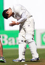 Ross Taylor winces in pain after being struck on the wrist