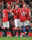 Wayne Rooney's team-mates celebrate the striker's goal