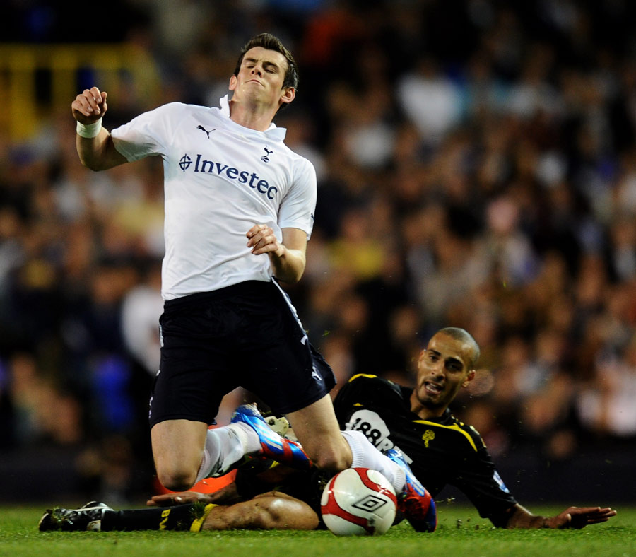 Gareth Bale is challenged by Darren Pratley