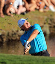 Ernie Els hacks the ball out of the mud