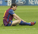 Lionel Messi sits on the turf