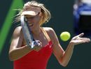 Maria Sharapova returns the ball to Caroline Wozniacki