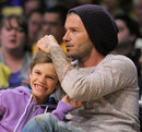 David Beckham watches the action with his son Romeo