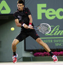 Novak Djokovic powers into a backhand