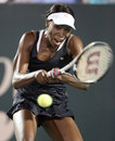 Venus Williams drives through a backhand