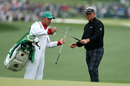 Darren Clarke takes his putter from his caddie