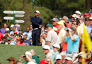 Tiger Woods leans away as his drive veers offline