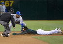 Jemile Weeks of the Oakland Athletics is tagged out at second base by Alcides Escobar 
