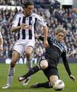 Jonas Olsson challenges for the ball
