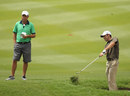 Charl Schwartzel hacks out of the rough during practice