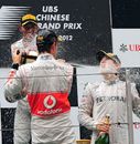 Nico Rosberg is sprayed with champagne by Lewis Hamilton and Jenson Button
