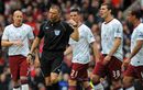 Aston Villa players argue with referee Mark Halsey