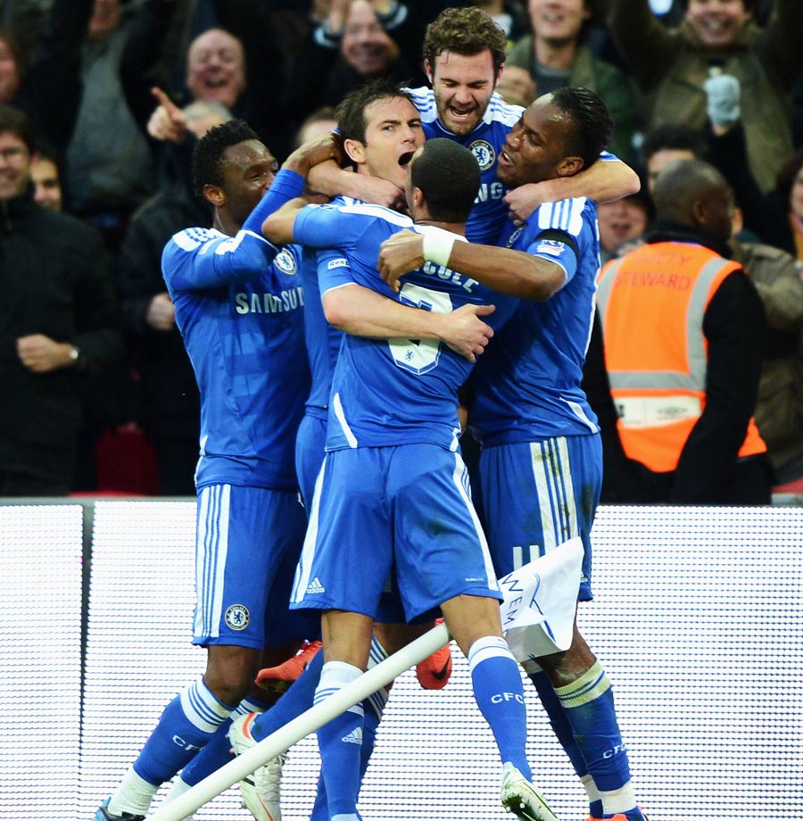 Frank Lampard gets mobbed by his team-mates after scoring