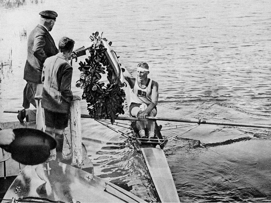Henry Pearce was rewarded with a garland for taking gold in the single sculls