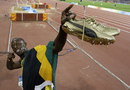 Usain Bolt celebrates winning his third gold medal in the 4x100m relay
