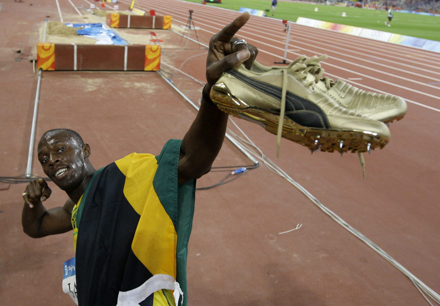 Usain Bolt celebrates winning his third gold medal in the 4x100m relay