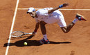 Novak Djokovic stoops to reach a return