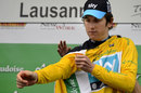Geraint Thomas dons the yellow jersey