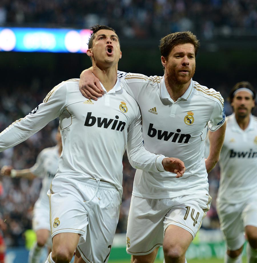 Cristiano Ronaldo celebrates scoring with Xabi Alonso