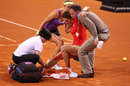 Victoria Azarenka helps an injured Andrea Petkovic