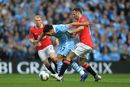 Ryan Giggs and Carlos Tevez battle for the ball
