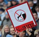 Football fans hold up a No Diving sign