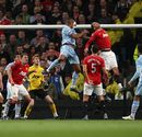 Vincent Kompany rises high to head home the opening goal of the game
