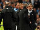 Roberto Mancini exchanges words with Sir Alex Ferguson
