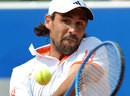 Marcos Baghdatis returns the ball to Dustin Brown