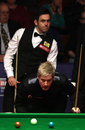Ronnie O'Sullivan looks on as Neil Robertson lines up a shot