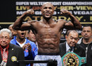 Floyd Mayweather Jnr. flexes during his weigh-in for his super-welterweight title fight against Miguel Cotto