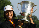 Rickie Fowler poses with the trophy