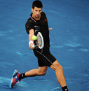 Novak Djokovic slides in on a backhand