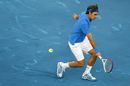 Roger Federer plays a drop volley