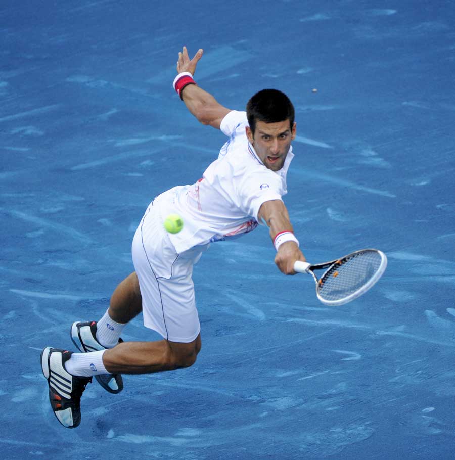 Novak Djokovic lunges for a backhand
