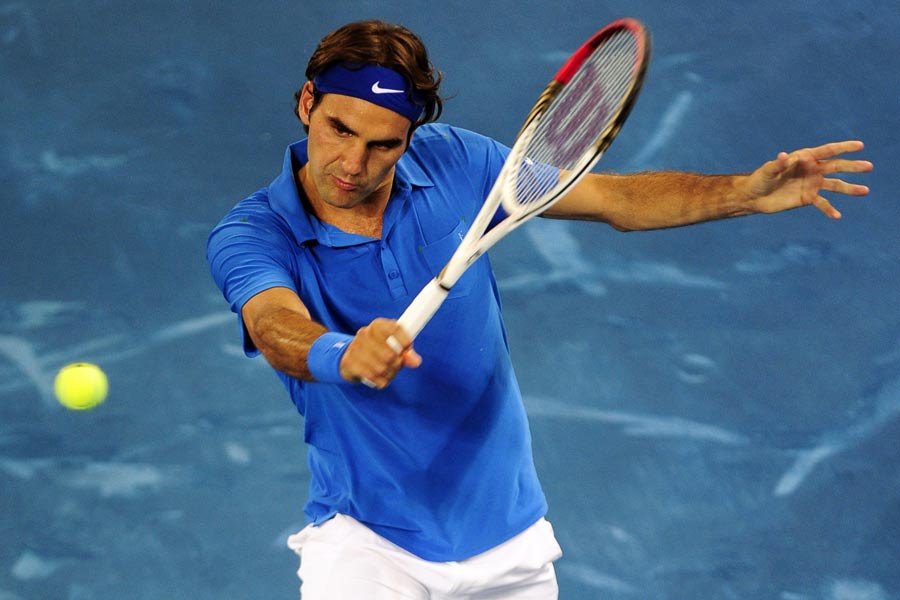 Roger Federer plays a backhand