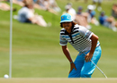 Rickie Fowler bends over after a close shave