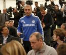 Roberto Di Matteo walks past television cameras and journalists 