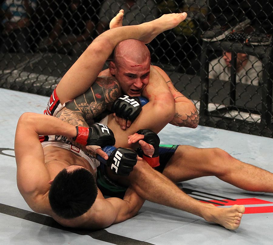 Chan Sung Jung attempts to secure a triangle choke against Dustin Poirier