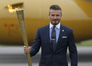 David Beckham holds the Olympic flame