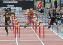 Jessica Ennis clears a hurdle on her way to victory in the 100m