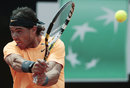 Rafael Nadal returns the ball to Novak Djokovic