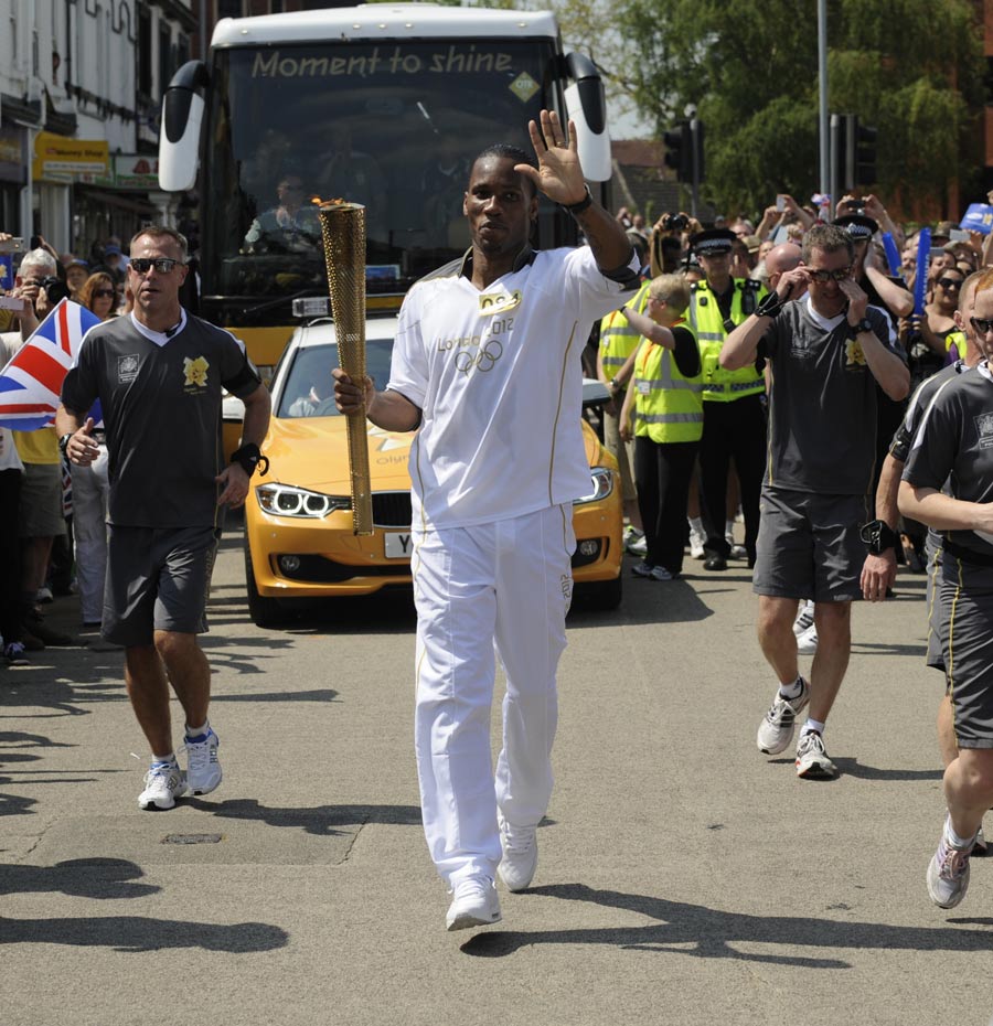 Didier Drogba carries the Olympic flame