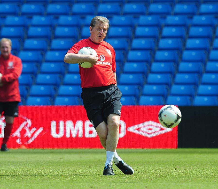 Roy Hodgson kicks a ball during a training session 