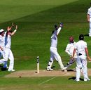 England's players celebrate the wicket of Shivnarine Chanderpaul