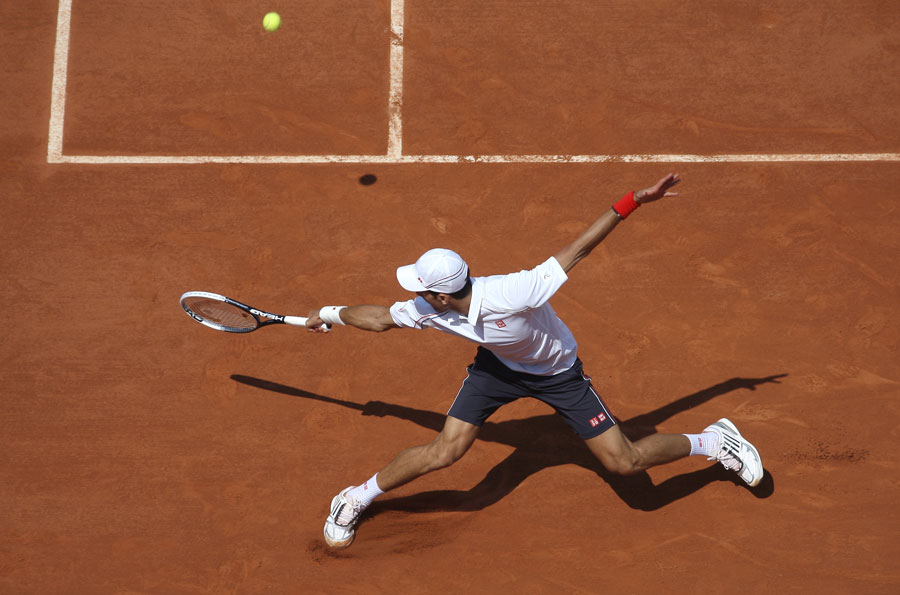 Novak Djokovic slides in to reach a shot