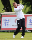 Wayne Rooney practises his swing