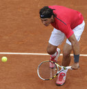 Rafael Nadal stoops to reach a dropshot