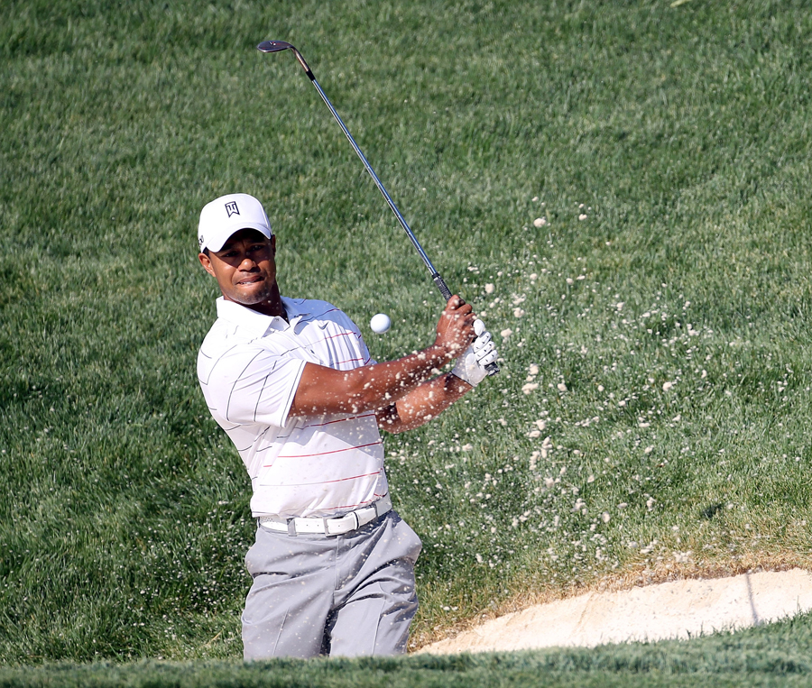 Tiger Woods escapes from a bunker
